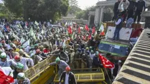 Noida: Farmers and Kisan Ekta Sangh members break police barricades during their protest march demanding for the expansion of minimum support prices (MSP) and other benefits, in Noida, Monday, Dec. 2, 2024. (Photo: PTI)