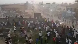 People scramble in Nzerekore, Guinea, where local officials said a deadly stampede ensued at a stadium following fan clashes during a soccer match, December 1, 2024, in this still image obtained from a social media video. | Photo Credit: Reuters